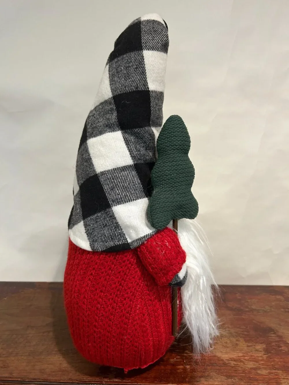 Christmas Holiday Gnome with bean bag base and bell on cap holding a tree